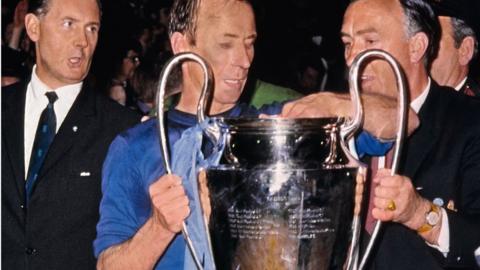 Bobby Charlton receiving the European Cup after Manchester United defeated Benfica in 1968
