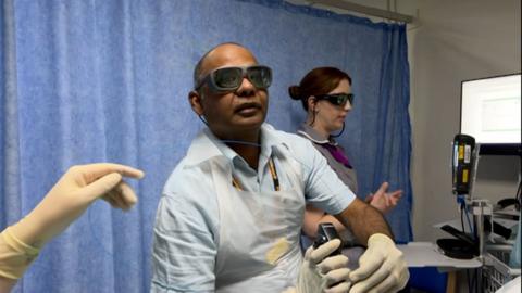 A doctor carrying out a procedure in a hospital