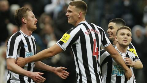 Newcastle players celebrate after scoring