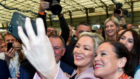 Sinn Féin deputy leader Michelle O"Neill and party leader Mary Louise McDonald take a selfie with supporters