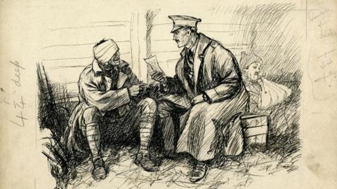 Pen and ink drawing of a soldier with a bandaged head and eye sitting on the ground beside an officer who is sitting on a box. He is leaning forward reading a letter to the soldier. Behind the officer is a slighly fainter drawing of another man lying back against the wall. He is wearing a soft hat, smoking a clay pipe and has his arm in a sling. 