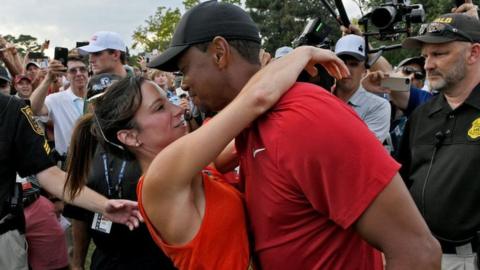 Tiger Woods and Erica Herman celebrate after a golf event in 2018