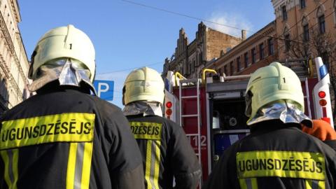 Firefighters respond to a deadly fire in a hostel in Riga, Latvia, 28 April 2021