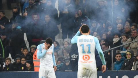 Marseille players take cover from firework