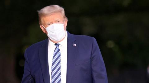 Trump wearing white mask