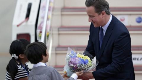 David Cameron receives flowers from Japanese school children upon his arrival at Chubu Centrair International Airport in Tokoname, Aichi Prefecture, central Japan, 25 May 2016