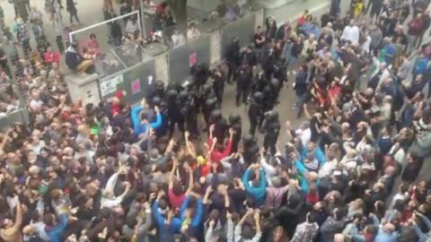 Crowd in Barcelona and riot police