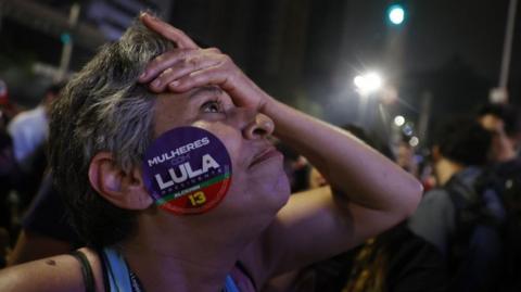 Supporters of former president and presidential candidate Luiz Inacio Lula da Silva celebrate while the partial results of the Brazilian elections are being announced on Paulista Avenue in Sao Paulo, Brazil, 02 October 2022
