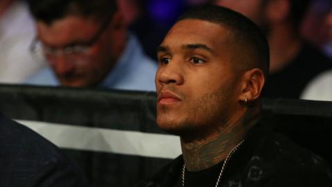 Conor Benn sits ringside at a fight