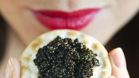 A woman about to eat caviar