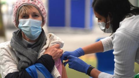 A woman being vaccinated