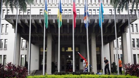 Workers hoist the national flags of Taiwan's diplomatic allies at the foreign ministry in Taipei, Taiwan (August 2019)