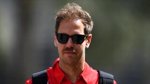 Vettel walking out of the paddock before the final practice in Bahrain