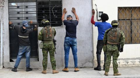 Members of the Army's Elite Forces frisk men and check their identities during a patrol in the streets of Moran, a neighbourhood in northern Quito, on 11 January 2024