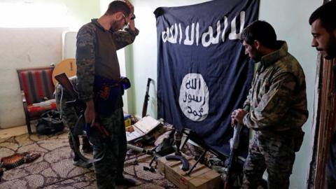 SDF fighters with a captured IS fag