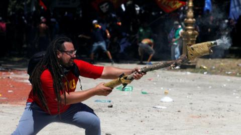 Demonstrators clash with police as lawmakers debate a pension reform measure, in Buenos Aires