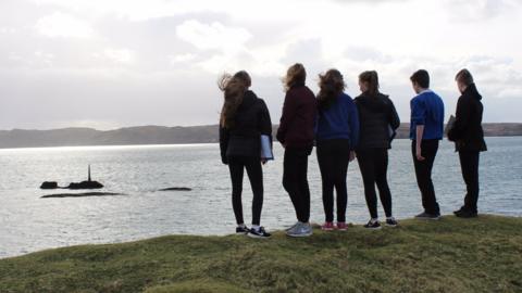 School pupils look out to the site of the Iolaire Disaster