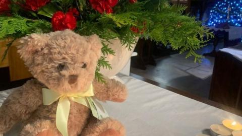 Photo of teddy bear in church at Christmas