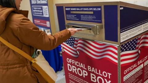 Voters drop off ballots in a box in San Francisco