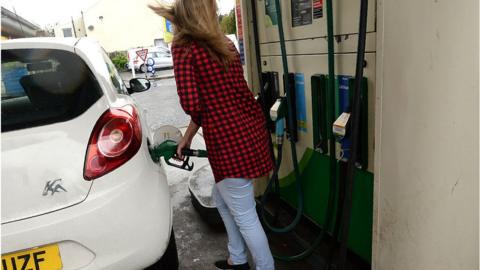 Woman at a petrol station