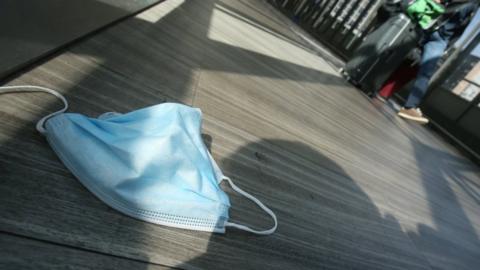 A protection mask lies on the ground at Frankfurt Airport, as the spread of the coronavirus disease (COVID-19) continues in Frankfurt, Germany, April 1, 2021.