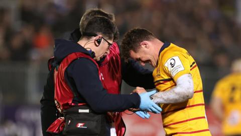 Burns receives treatment on his elbow injury during Ulster's loss to Bath on Saturday