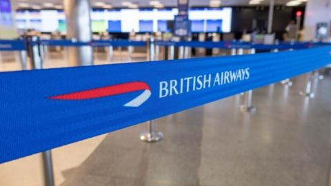 Ribbon with British Airways logo. Interior of London City Airport