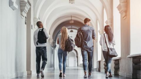 Students walking along a university corridor