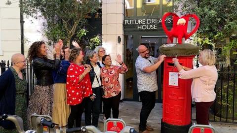 The postbox topper is presented to the Future Dreams charity by BBC Radio Leicester presenter Ady Dayman