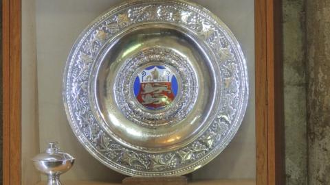 Decorative large silver plate and cup, with the plate having an enamel coat of arms in the middle