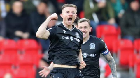 Scott Wharton of Blackburn Rovers celebrates after scoring the team's first goal during the Sky Bet Championship match between Stoke City and Blackburn Rovers at Bet365 Stadium on November 25, 2023 in Stoke on Trent, England.