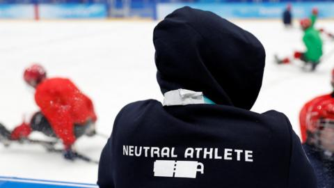 A team member of the team formerly known as the Russian Paralympic Committee displays the words 'neutral athlete' with a piece of tape covering the word Russia on their clothing during training in Beijing