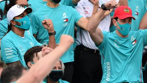 Lewis Hamilton and Toto Wolff celebrate with the Mercedes team