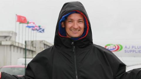 Richard Cooper pictured in the wind and rain at Bishopscourt