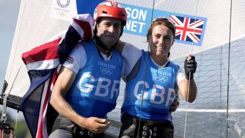 John Gimson and Anna Burnet celebrate winning silver in the mixed Nacra 17 class during the Sailing