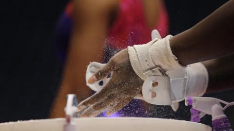 Generic shot of a gymnast chalking hands