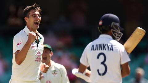 Australia fast bowler Pat Cummins (left) celebrates dismissing India captain Ajinkya Rahane (right) in the third Test