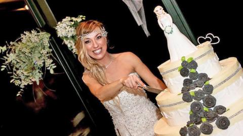 Laura Mesi, who married herself, cuts her wedding cake