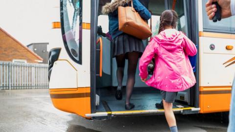 Children getting on a bus