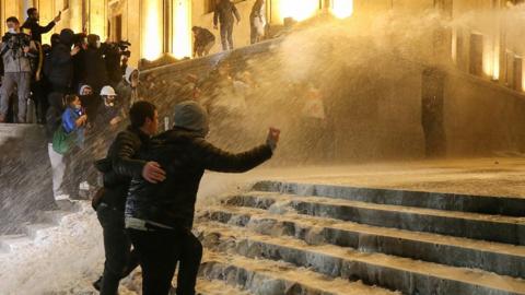 Police in Georgia have fired water cannon and pepper spray at protesters.