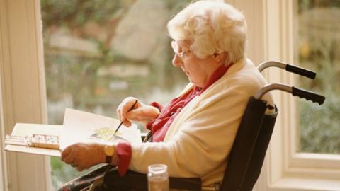 Elderly woman painting