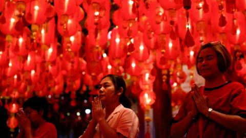 People pray during Lunar New Year's eve in Bangkok, Thailand