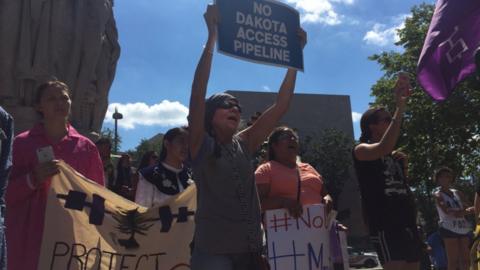 Protesters outside the US District Court in Washington cheer as members of Native American community rally against the construction of the Dakota Access pipeline.