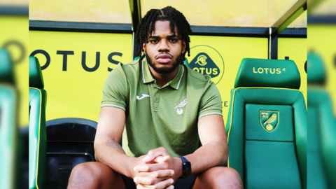 Jayden St Paul sat in the Norwich City FC dugout