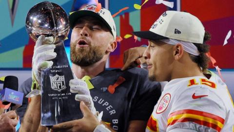 Travis Kelce and Patrick Mahomes being presented with the Lombardi Trophy after the Kansas City Chiefs win Super Bowl 57