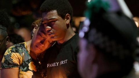 Veronica Hartfield (L), widow of slain Las Vegas Metropolitan Police Department Officer Charleston Hartfield, and their son Ayzayah Hartfield, 15, attend a vigil for Charleston Hartfield at Police Memorial Park in Las Vegas.