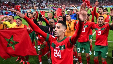 Morocco players celebrate their World Cup in over Portugal