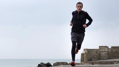 Paul running by the coast