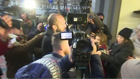 Andrew Tate walks through press pack in Romania