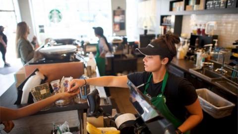 A Starbucks barista fulfills an order in a South Philadelphia store.